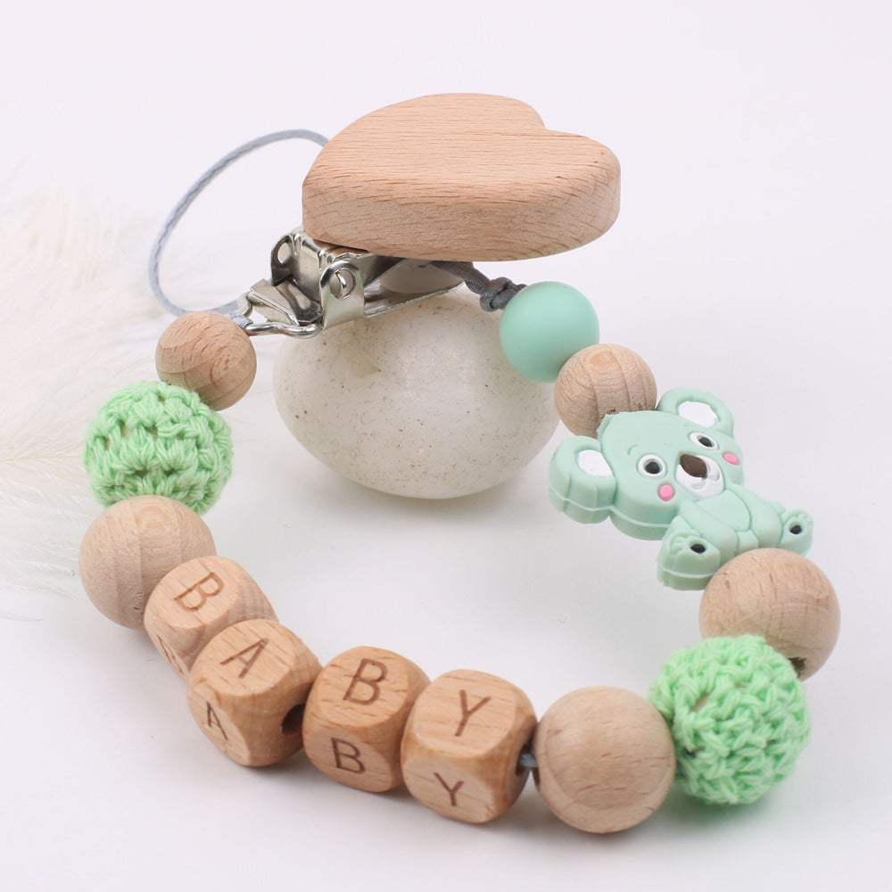 Oluuu. Baby Beruhigungsclip aus Buchenholz – Mit Mundkette